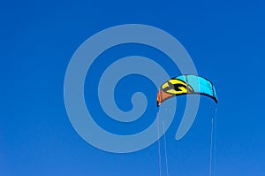 Closeup of kite surf flying over the blue sky