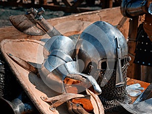 Closeup of a knight`s helmet, gloves, shield and battle axe