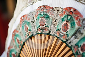 closeup on lacework of a dancers traditional fan photo