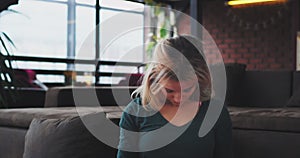 Closeup lady with blonde hair have a home yoga time , she stretching her body in the morning in a modern loft interior