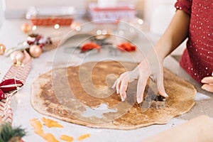 Closeup of a lady cutting CHristmas figured cookies