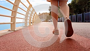 Closeup of lady legs walking along unpolluted pavement, concept of clean city