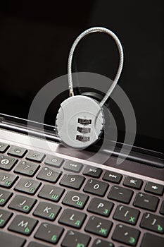 Closeup of laptop with cipher padlock. Information security concept.