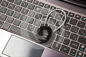 Closeup of laptop with cipher padlock. Information security concept.