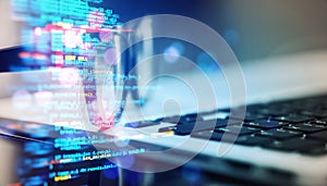 Closeup of laptop keyboard with overlay of programming code and blurred background