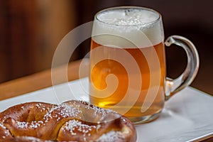 Glass mug of beer and pretzel