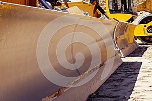 Closeup of large industrial bulldozers.