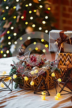 Closeup of a large stack of wrapped Christmas presents of varying sizes and shapes and Christmas decorations in Xmas