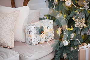 Closeup of a large stack of wrapped Christmas presents of varying sizes and shapes in Xmas interior.