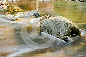 Closeup of large stones set in the water Blocking the passage of water in the park
