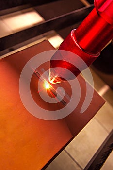 Closeup laser engraver working and engraving flat ceramic stone