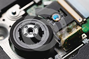 Closeup of a laser head and dvd rom drive with boards. Writing and reading with laser technology