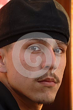 A closeup of a latino gang member looking fearsome