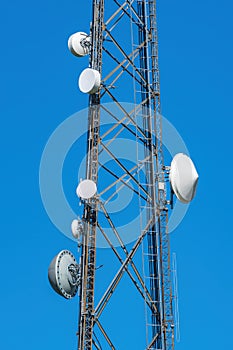Closeup of lattice cell tower with microwave antennas, vertical - Davie, Florida, USA