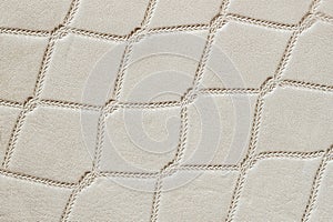 Closeup on leather texture surface with rhombus stamped pattern. Modern pattern, background