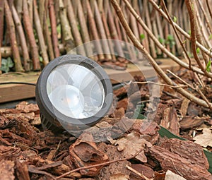 Closeup of a LED graden lamp, stuck in a flowerbed