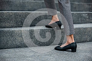 Closeup legs of businesswoman hurry up walking on stairway