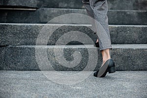 Closeup legs of businesswoman hurry up walking on stairway