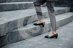 Closeup legs of businesswoman hurry up walking on stairway