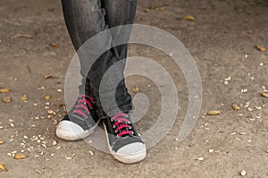 Closeup of legs in trousers and sneakers