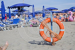 Closeup of lifeguard orange life buoy on the beach