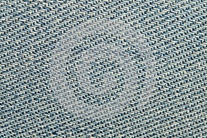 Closeup of a light blue jeans denim fabric. Macro photography. Texture for backgrounds.