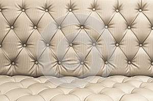 Closeup Light brown or beige color artificial leather texture of sofa