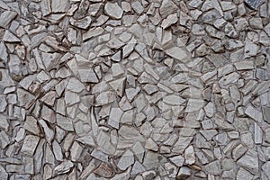 Closeup of light gray gravel pebble dash