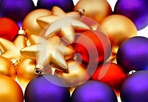 Closeup of lila, red and golden baubles photo