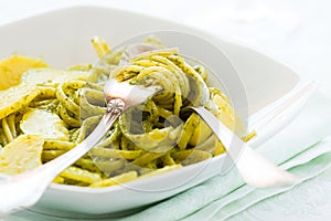 Closeup of linguine pasta with pesto genovese and potatoes