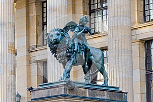 Closeup of lion and angel sculpture in front of Konzerthaus at Gendarmenmarkt square, Berlin, Germany photo