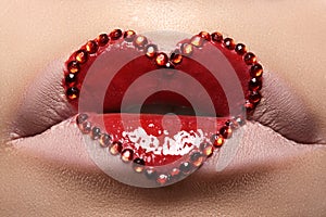 Closeup lips with red heart make-up & rhinestones. Valentines Day style