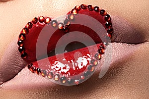 Closeup lips with red heart make-up & rhinestones. Valentines Day style