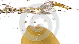 Closeup liquid with lemons. Abstract water background