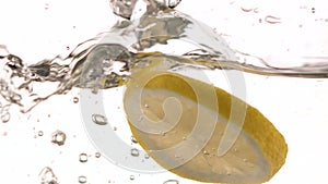 Closeup liquid with lemons. Abstract water background