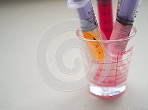 Closeup liquid medicine in syringe in glass