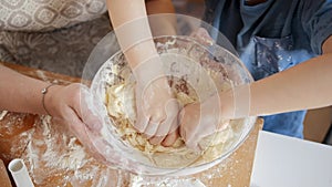 Closeup of little boy mixing dough in big glass bowl. Children cooking with parents, little chef, family having time