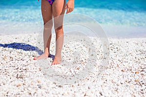 Closeup of little girl feet on tropical sandy