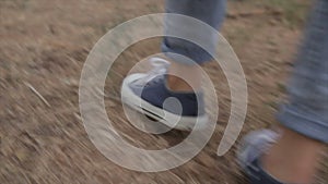 Closeup on little girl legs that running in the forest