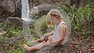 Closeup Little Girl Makes Selfie with Phone at Waterfall