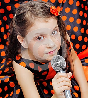 Closeup little girl with microphone