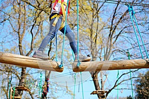 Closeup Little girl playing at adventure park climbing and addressing balance challenges for self esteem