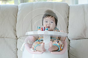 Closeup little girl sit on chair for children