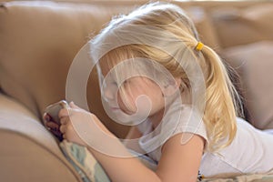 Closeup of little girl watching a show on smartphone