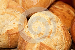 Closeup of loaves of round crusty bread.