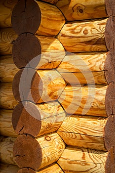 Closeup of a log wall construction with a swedish cope log profile. Corner of the old wooden blockhouse