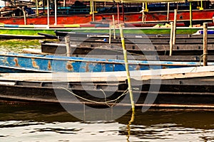 Closeup of long tailed boat mooring on the shore.