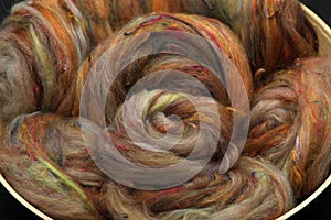 Closeup of lots of beautiful sheep wool fibres in a roving ready for spinning yarn on a spinning wheel as a hobby