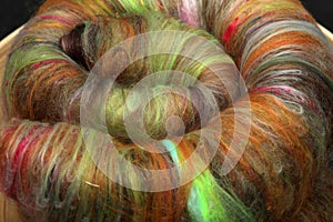 Closeup of lots of beautiful sheep wool fibres in a roving ready for spinning yarn on a spinning wheel as a hobby