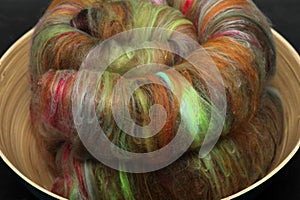 Closeup of lots of beautiful sheep wool fibres in a roving ready for spinning yarn on a spinning wheel as a hobby